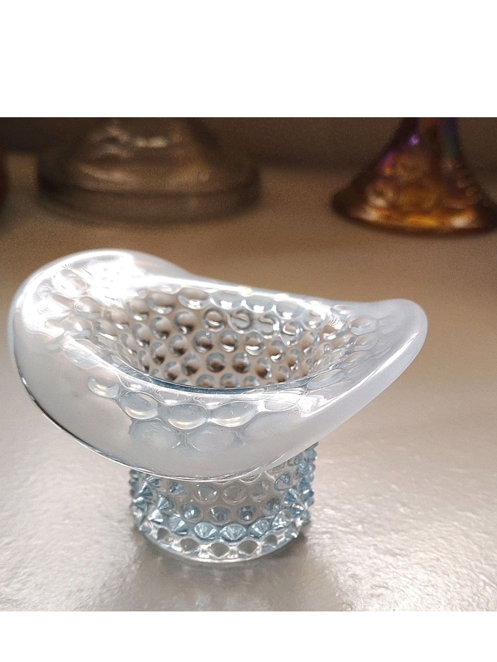 This is a vintage Duncan & Miller light blue opalescent hobnail glass top hat to